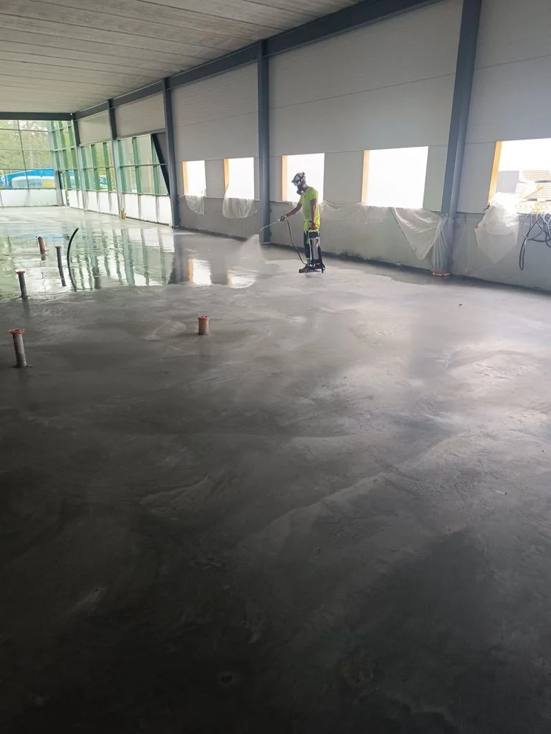 Coating concrete floor with chemical hardener